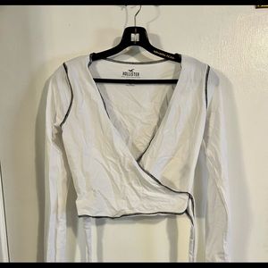 Hollister Must Have CollectionWhite with black trim wrap around baby tee. Size S